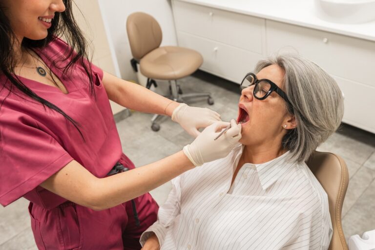 A concerned patient holding their jaw with visible swelling, alongside a dentist explaining potential tooth implant side effects using a model. No text on image.