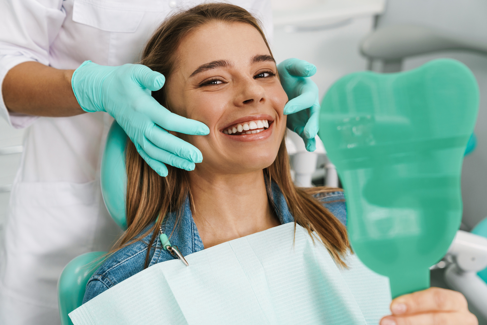 Periodontist consulting a patient about gum health in a modern dental office