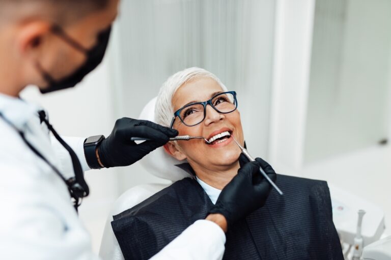 Periodontist consulting with patient about dental implants