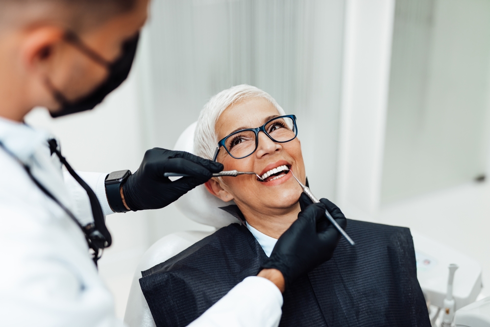 Periodontist consulting with patient about dental implants