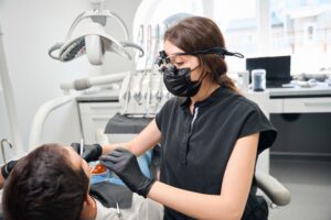 Patient consulting with a periodontist about gum health in a modern dental office.
