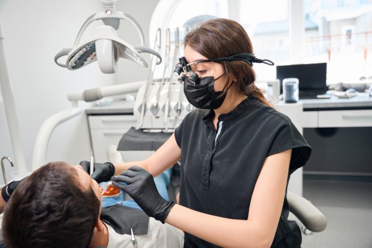 Patient consulting with a periodontist about gum health in a modern dental office.