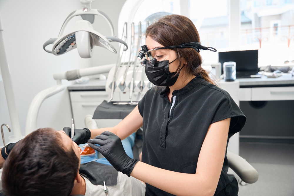 Patient consulting with a periodontist about gum health in a modern dental office.
